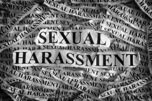 torn piece of paper with the words sexual harassment for a sexual harassment lawyer newark
